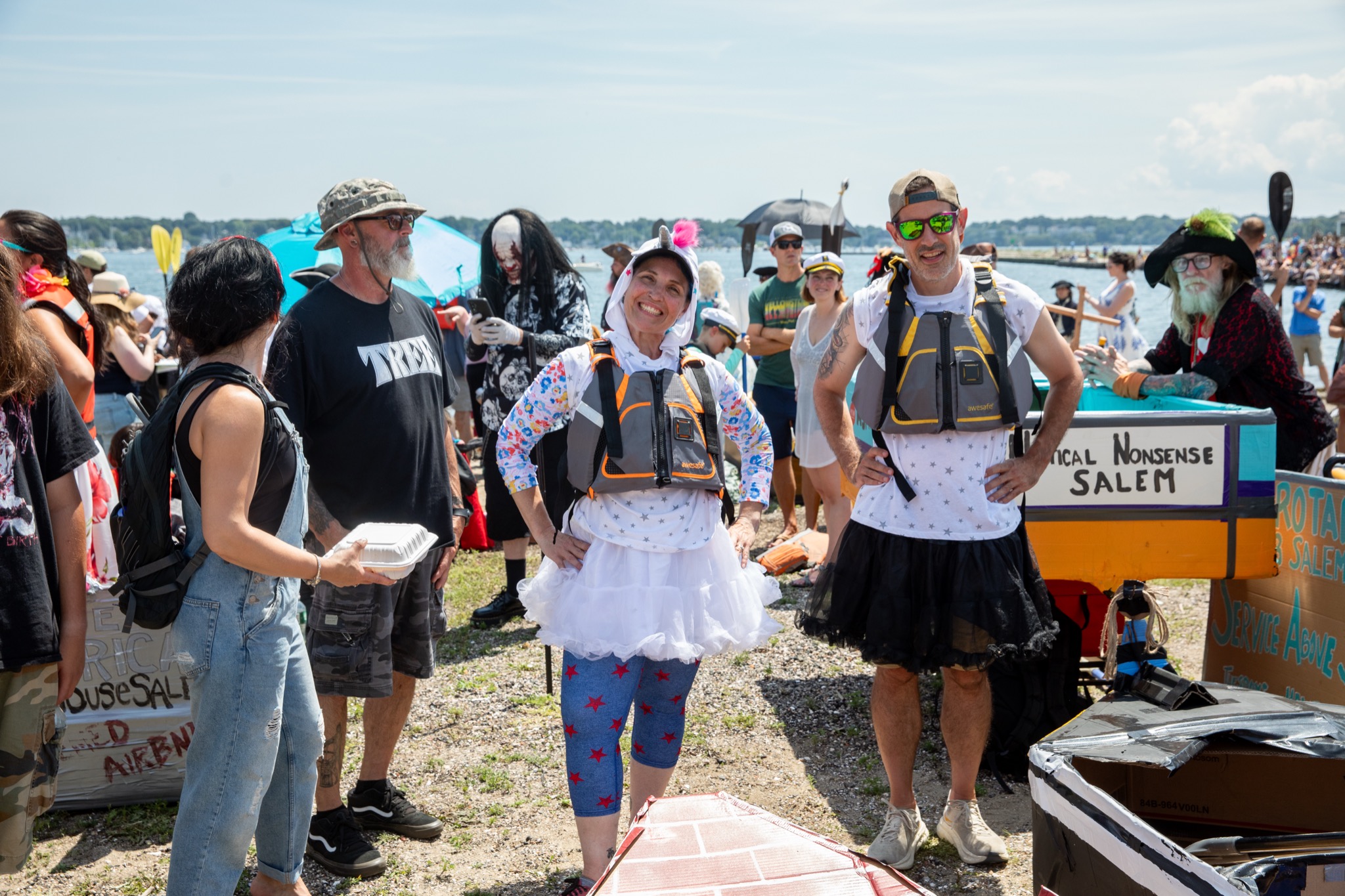 Costumed crew in tutus with their Nautical Nonsense cardboard boat at the Salem 400 Cardboard Regatta in Salem MA