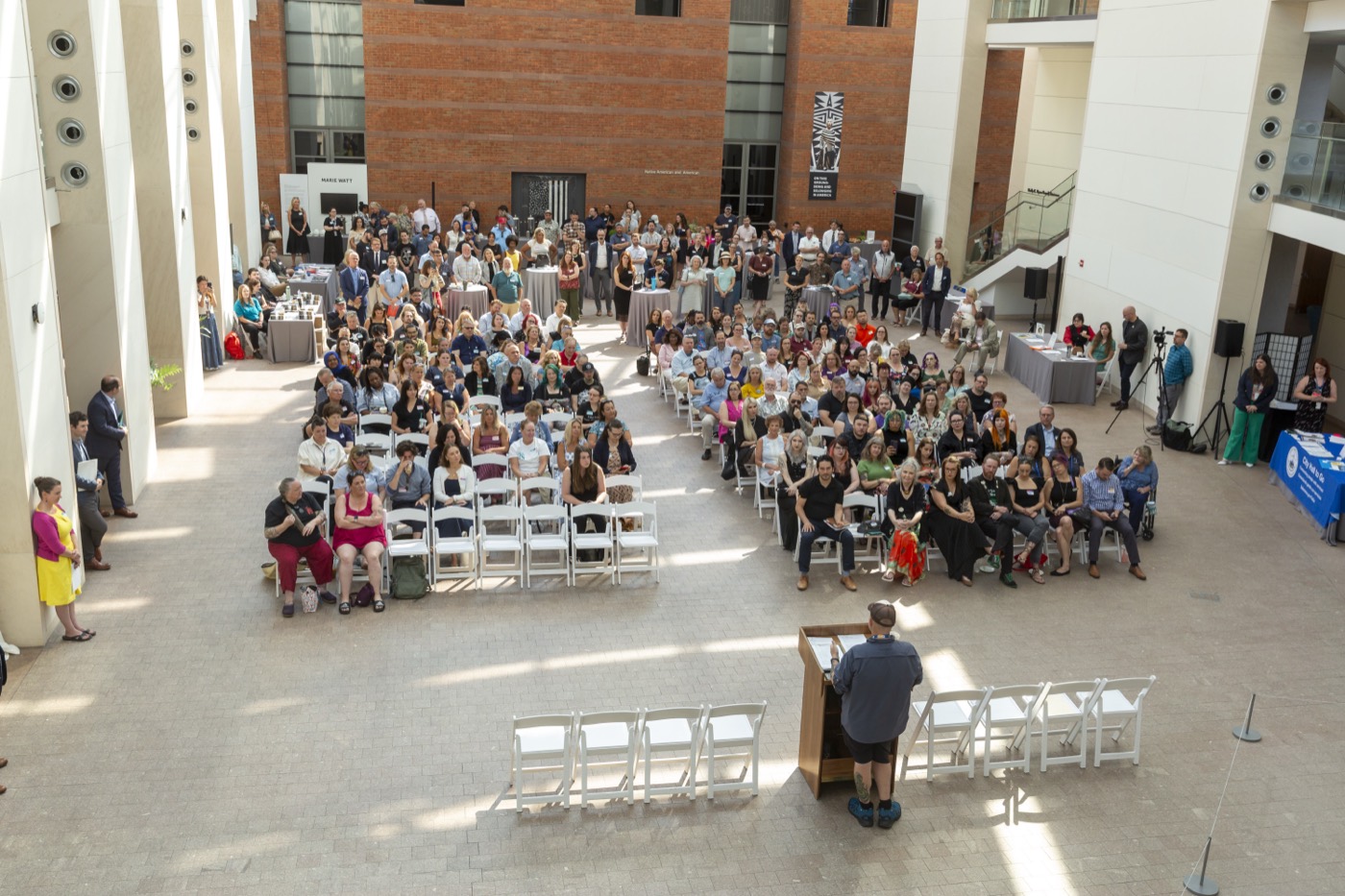John Andrews of Creative Collective speaking with Salem small-business owners at the August 2026 Salem Biz Town Hall in the Peabody Essex Museum Atrium.