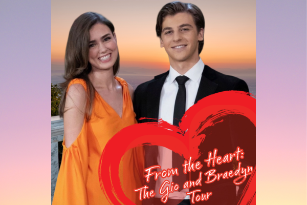 A woman in an orange dress and a man in a black suit stand together, smiling, with a sunset view behind them. Red heart graphics and text read “From the Heart: The Gio and Braedyn Tour.”.