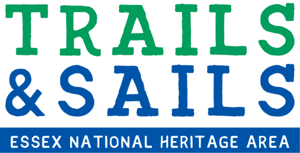 Logo with “TRAILS & SAILS” in large green and blue letters. Below, “ESSEX NATIONAL HERITAGE AREA” appears in smaller white text on a blue background.