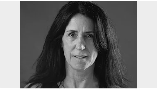 Black-and-white portrait of poet Jennifer Martelli with long dark hair, looking at the camera