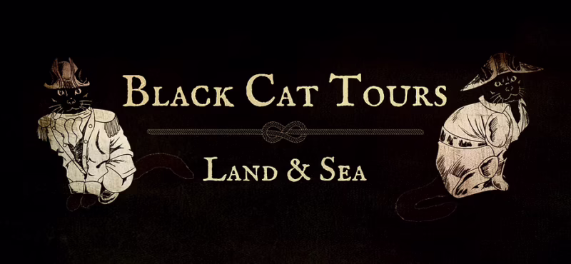 Illustration with the text “Black Cat Tours Land & Sea.” On the left, a black cat in a white coat and hat; on the right, one in a beige sailor outfit. The black background hints at the intrigue of a Historic Day Tour adventure.