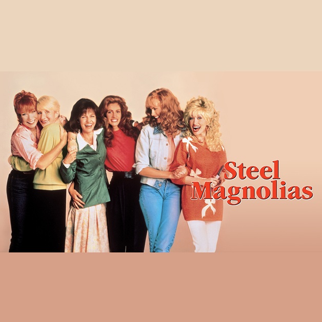 Six women stand together, smiling and laughing in bright, 1980s-style outfits. Against a plain background, the title “Steel Magnolias” appears in bold red text on the right side of the image.