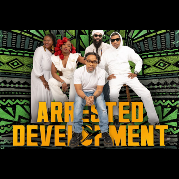 Five people pose in front of a green and black patterned background with “Arrested Development” written in yellow. Dressed mostly in white, they capture the quirky style of the TV series, highlighting this acclaimed comedy ensemble.