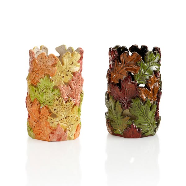 Two cylindrical ceramic candle holders are shown, each decorated with overlapping autumn leaves. The right holder has a glossy finish, while the left has a matte finish—perfect as a leaf lantern for cozy evenings or inspired by lantern painting styles.