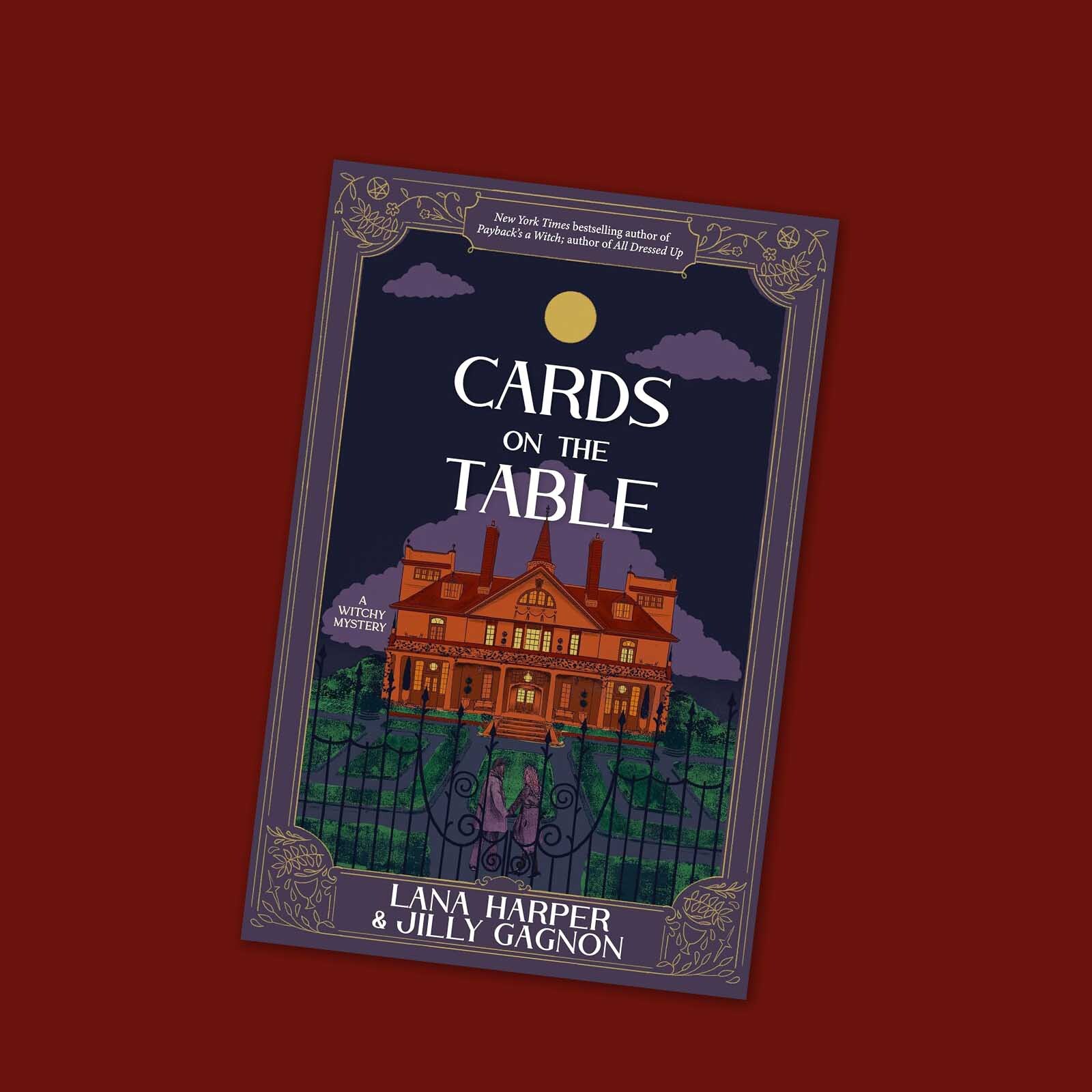 Book cover for Cards on the Table by Lana Harper and Jilly Gagnon, featuring a large house, a full moon, and two figures standing behind a fence.