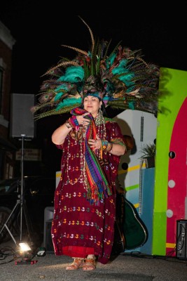 a woman in a colorful dress and headdress.