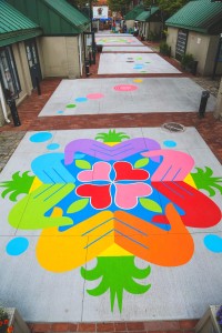 a sidewalk with a colorful flower design painted on it.
