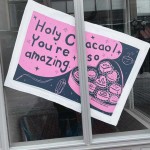 a window with a sign on it that says, holy c you're amazing.