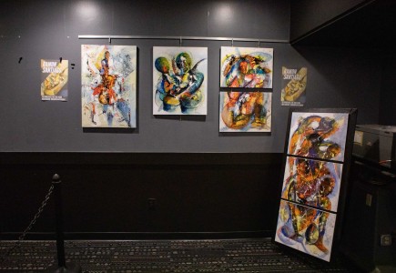 a group of paintings hanging on a wall.