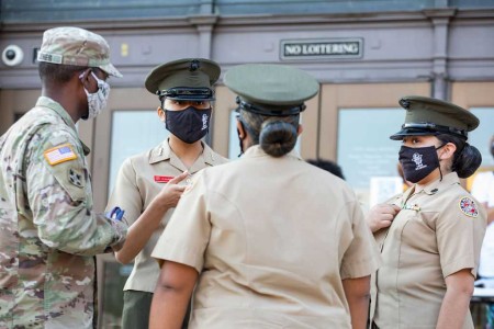 a group of military personnel wearing face masks.