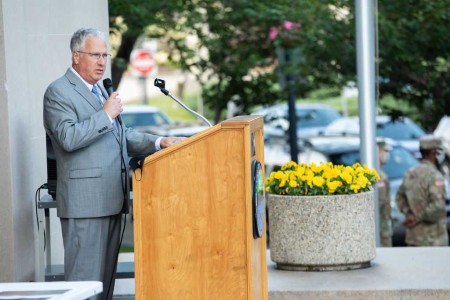a man standing at a podium giving a speech.