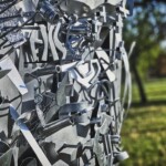 a close up of a metal sculpture in a park.