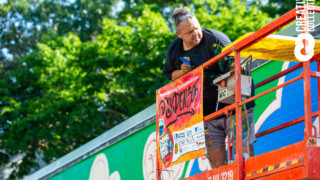 Golden305 creates a mural at a local school for Beyond Walls