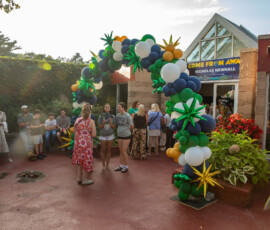 A balloon arch in green, navy, white and gold frames the entrance to North Shore Music Theatre as guests arrive for A Night for Patrick in Beverly