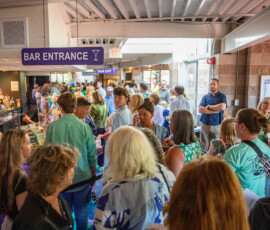 The lobby at North Shore Music Theatre packed with guests in green Patrick's Pack shirts before A Night for Patrick on August 24, 2026
